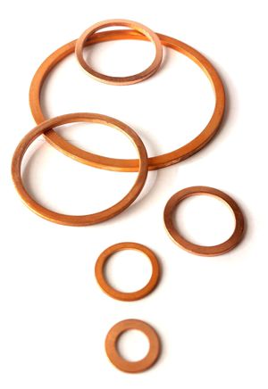 A variety of different sizes of copper washers
